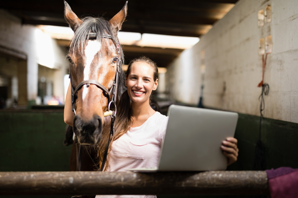 computer woman horse barn iStock-837946256