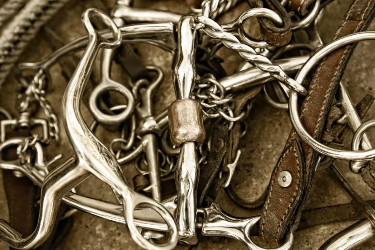 A pile of bridles and bits