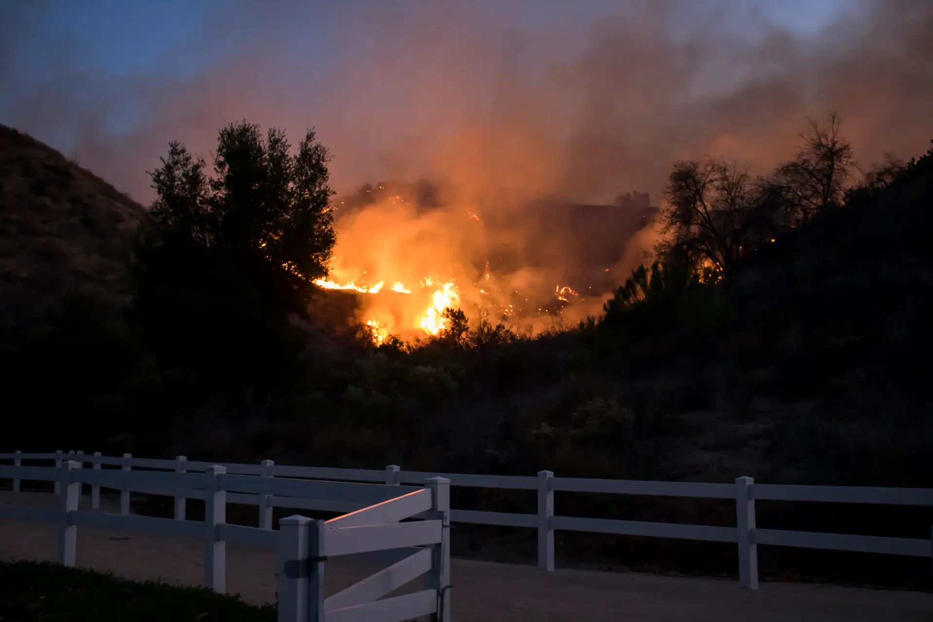 Fire Burns Beyond Park Fence in California Woolsey Fire