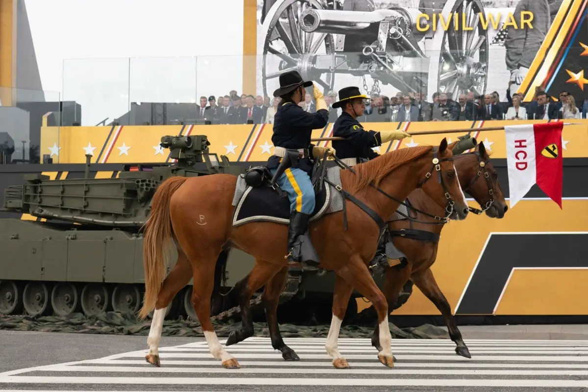 Soldiers with US Army's 1st Cavalry Division Horse Detachment salute the president during the Army's 250th birthday parade